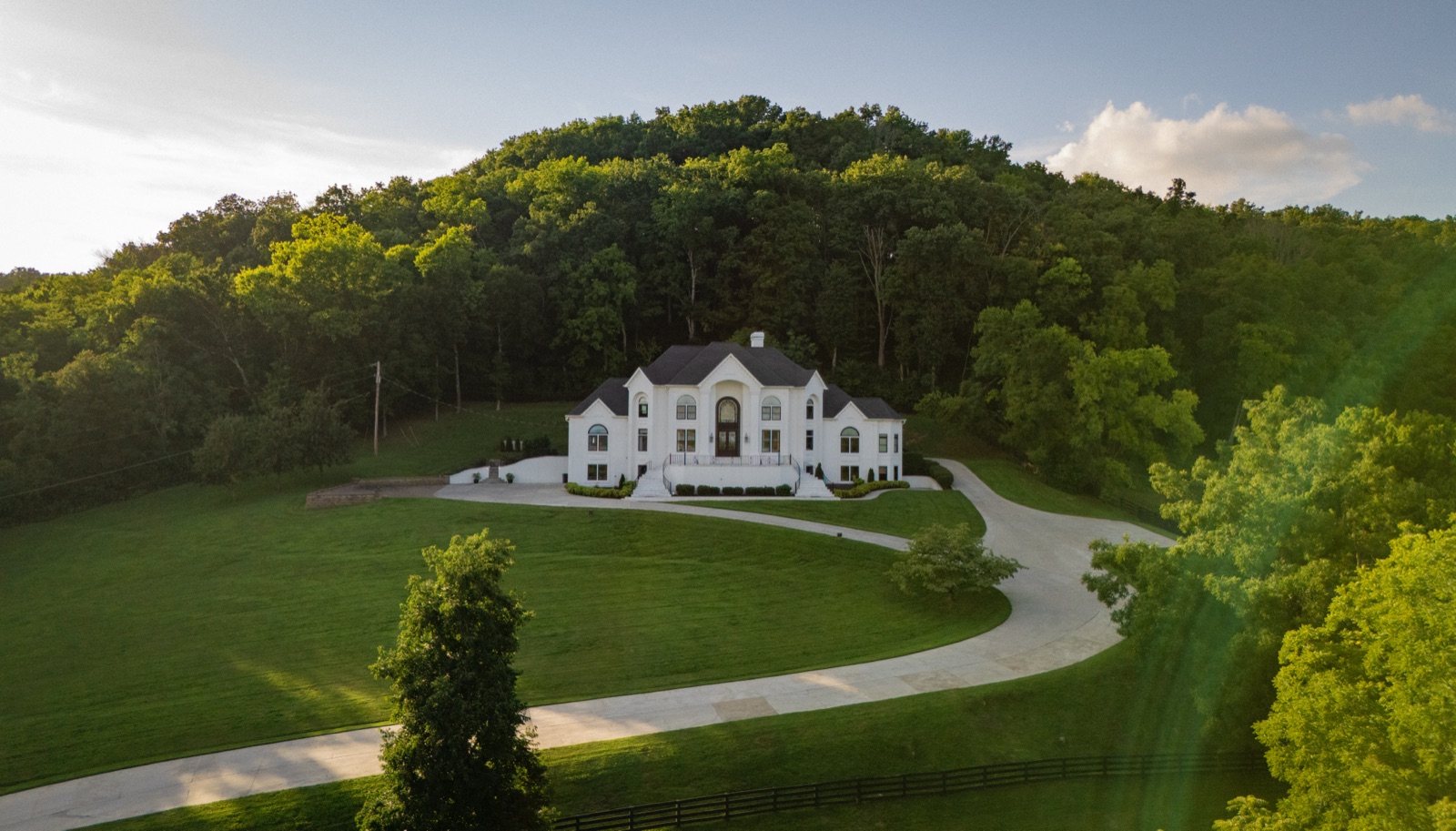 The estate at golden hour, set into its wooded hilltop above Williamson County.