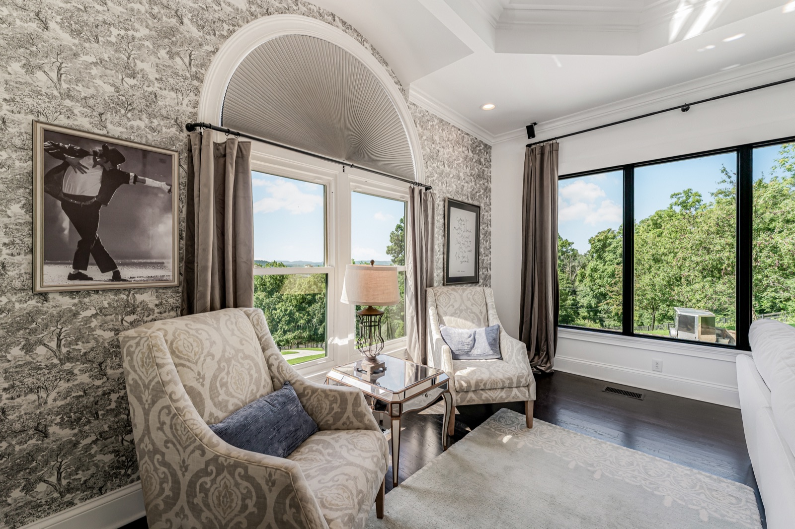Two chairs at the owner's-suite window, the county waiting beyond the glass.